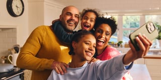 A smiling family taking a selfie