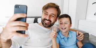 A parent taking a selfie with a child